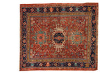 Antique Karaja rug with a serrated medallion, cherry red field, and navy blue borders.