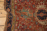 Close-up of the antique Karaja rug's navy medallion with serrated contour and rams horn motifs.