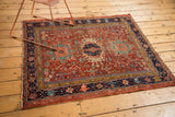 Corner detail of a hand-knotted Karaja rug, displaying intricate geometric patterns, rich colors, and edge tatter.