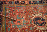 Intricate Karaja rug pattern with navy serrated medallion, cherry red, teal, and ivory.