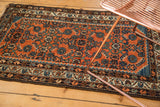 Intricate serrated corner spandrels and Herati motif on a brick red vintage Hamadan rug.