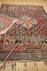 Vintage Malayer rug with madder root red, navy herati motif and visible knot wear.