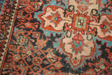 Detail of vintage Malayer rug: pale rose quatrefoil medallion and madder root red Herati field.