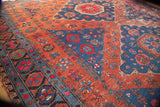 Antique Soumac carpet detail showing geometric floral interpretations and halved medallions in rich madder red and indigo.
