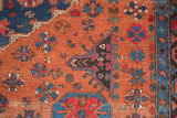Geometric indigo blue motifs and madder root red field, showing patinated texture on an antique Soumac.