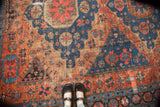 Antique Caucasian Soumac carpet, blush red and indigo geometric field showing wear.