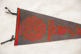 Red seal and collegiate text on vintage Pennsylvania University gray felt pennant.
