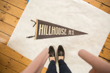 Aged dark gray felt Hillhouse H.S. pennant, with white lettering and felt ties.