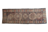 Antique Caucasian Moghan Kazak runner with a single column of gem-toned geometric medallions, 2'11