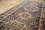 Antique Moghan Kazak runner displays geometric guls, cloud bands, and rich, gem-toned coloration.