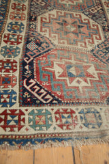 Moghan Kazak geometric patterns in rich navy, red, and ivory with mostly even pile wear.