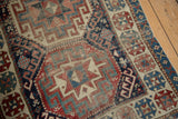 Intricate Moghan Kazak geometric motifs with navy, wine red, and antique ivory palette.