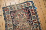 Geometric star and cloud band motifs of antique Caucasian runner in rich navy, wine red, and ivory.