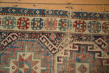 Geometric border of antique Moghan Kazak runner, showing cloud bands, wear, and rich jewel tones.