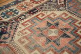 Moghan Kazak motifs: geometric guls, cloud bands, and zigzag patterns in ivory, blush, and blue.