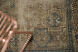 Visible wear, beige, brown, and sky blue geometric patterns on antique Chi Chi rug.