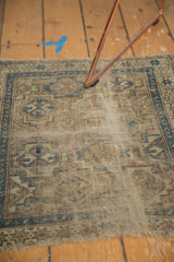 Fine knotting detail of antique Chi Chi rug with geometric medallions and evident wear.