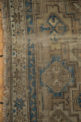 Chi Chi rug close-up: fine knotting, sky blue geometric motifs, and visible wear.