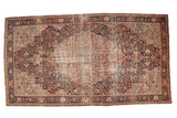 Antique Farahan Sarouk runner features an oblong starburst medallion, rococo vinery, navy field, and time-softened tones.
