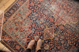 Antique Persian Farahan Sarouk rug featuring rococo medallion, dense millefleur field, and soft wear.
