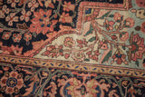 Antique Farahan Sarouk rug detail: scalloped medallion, millefleur vinery in soft reds, navy, ivory.