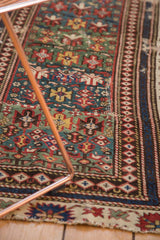 Antique Caucasian rug showing the distinct wide border and professionally performed seam.
