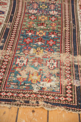 Antique Caucasian rug: worn teal, red, ivory geometric patterns and central seam.
