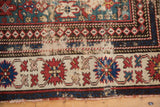 Antique Caucasian rug's multiple borders display significant wear, exposed foundation, and tatter.