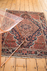 Navy rococo style corner spandrel and meandering vine border of a Josan Sarouk rug.