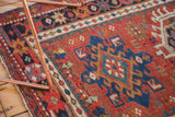 Hand-knotted Karaja rug showing hook-and-latch medallion and contrasting beaded border.