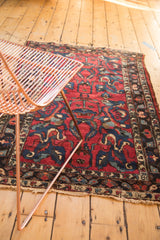 Raspberry red field, indigo blue arabesque florals, pinwheels, and tattered edge detail.