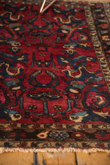 Intricate arabesque and blossomed floral design on the vintage Lilihan rug's rich red field.