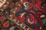 Lilihan rug corner with raspberry red, indigo blue arabesque blossoms and beige border.