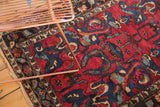 Vibrant raspberry red and indigo blue arabesque patterns on the vintage Lilihan rug.