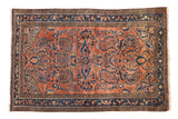 Vintage Lilihan rug with dusty rose field, blue floral medallion, and allover blossoming patterns.