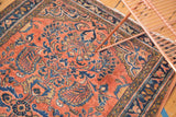 Detailed view of the vintage Lilihan rug's blossoming floral patterns in dusty rose, blue, and gold.