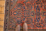 Lilihan rug corner with fringe, scalloped border, and dusty rose blossoming patterns.