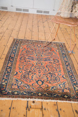 Vintage Lilihan rug corner detail, dusty rose field with blossomed florals and fringe.
