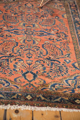 Blossoming blue floral motifs and low, even pile texture with fringed edge on vintage Lilihan rug.