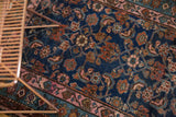 Hand-knotted Hamadan rug's indigo field, Herati motif, and pale blush meandering vine border.