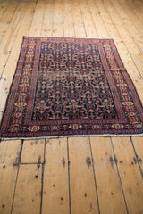 Vintage Senneh rug's navy central field featuring Herati pattern and subtle foundation wear.