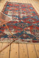 Antique Shirvan rug with worn cherry red, sky blue geometric pattern and tattered fringe.