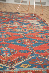 Intricate geometric patterns on an antique Shirvan rug with rich gem tones.