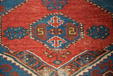 Antique Shirvan rug with bold geometric motifs in saturated cherry red and sapphire blue.