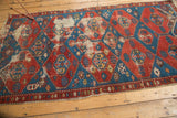Antique Shirvan geometric pattern in balanced cherry red and sky blue, with pile wear and frayed edge.