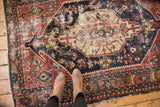 Worn geometric field of an antique Northwest Persian rug with exposed foundation and repair.