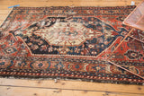 Antique Northwest Persian rug border detail, displaying visible wear, geometric motifs, and madder red palette.