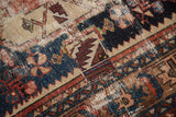 Antique Northwest Persian rug detail, showcasing worn geometric motifs, visible foundation, and color disparity.