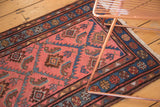 Vintage Lilihan rug corner showing serrated herati leaves, blue floral border, and fringed edge.