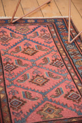 Dusty rose field with blue and brown serrated Herati leaves on a hand-knotted Lilihan rug.
